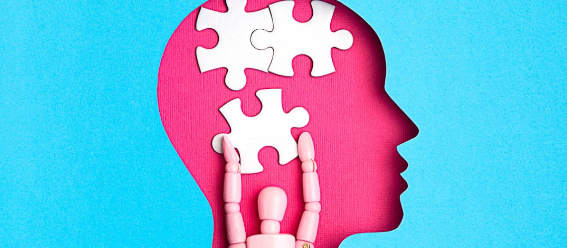 Help with mental illness concept. Papercut head with jigsaw puzzle pieces inside. Mental health problems, psychology, memory, logic, thinking process, solution search.